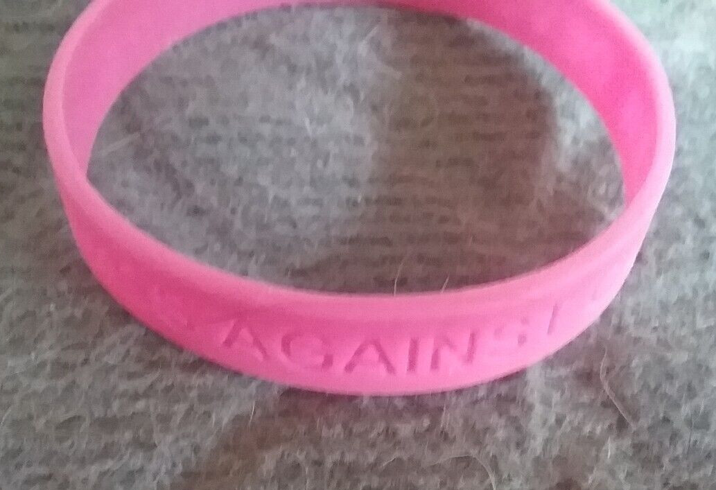 PINK PLASTIC WRISTBAND ” DEVOTED TO A CURE – COSMOS AGAINST CANCER “