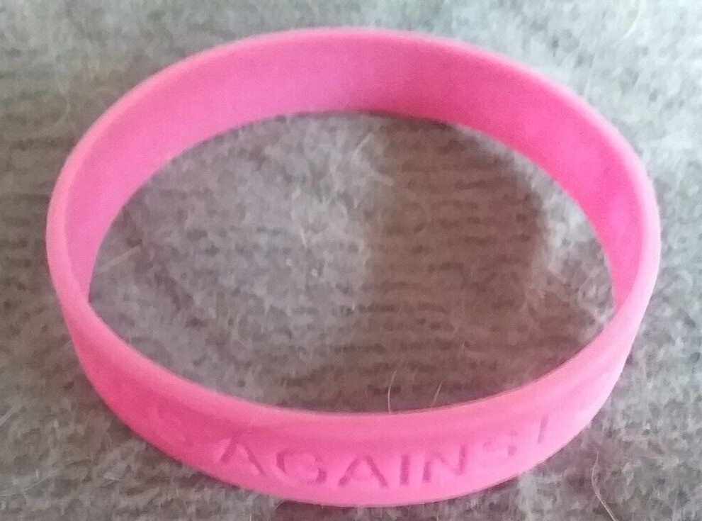 PINK PLASTIC WRISTBAND ” DEVOTED TO A CURE – COSMOS AGAINST CANCER “