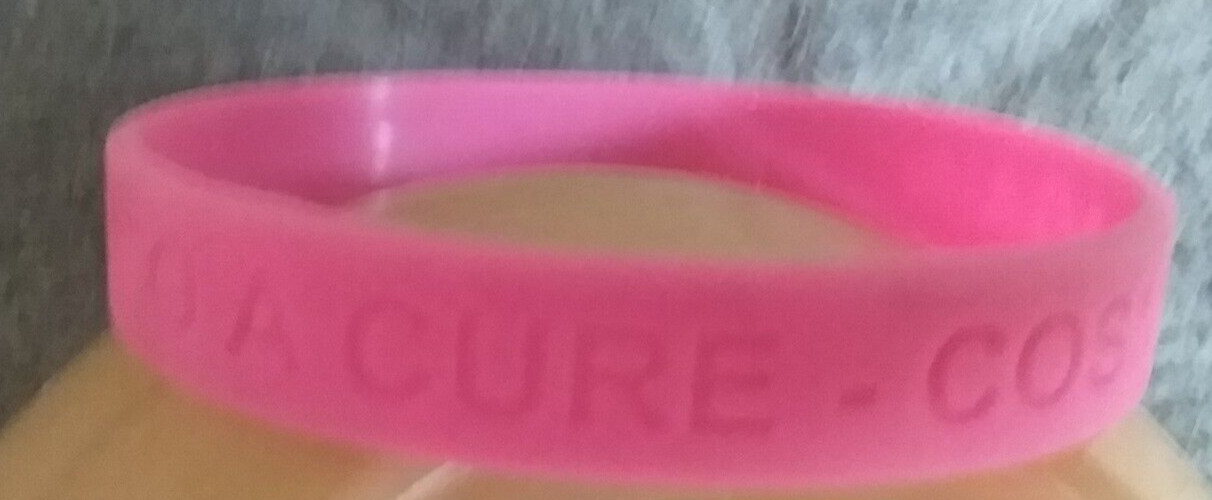 PINK PLASTIC WRISTBAND ” DEVOTED TO A CURE – COSMOS AGAINST CANCER “